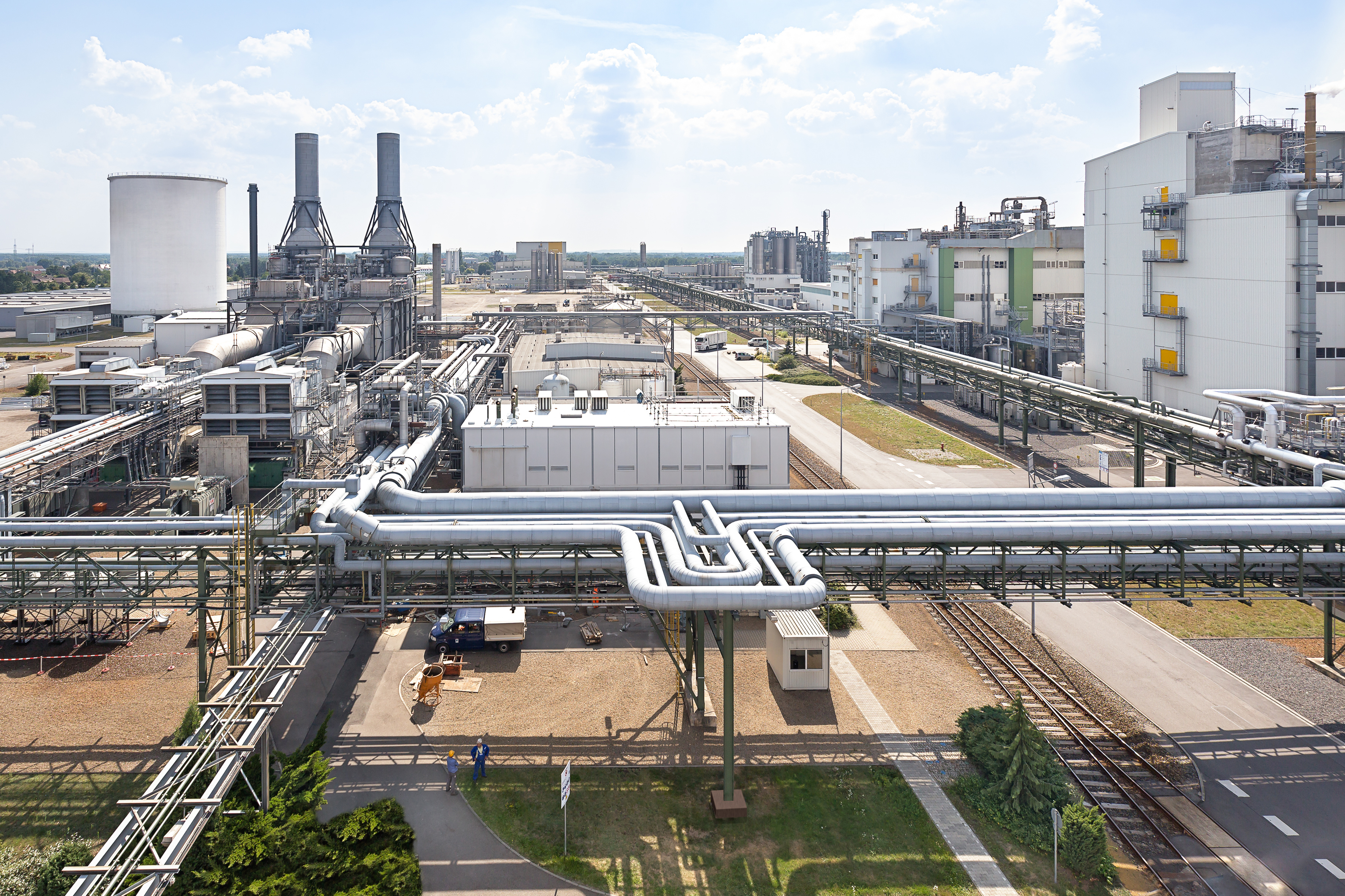 Chemical plant with process piping, storage tank and production buildings